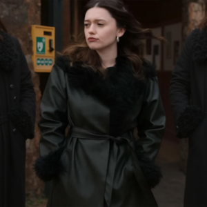 Woman wearing a stylish black leather coat with fur trim inspired by celebrity winter fashion.